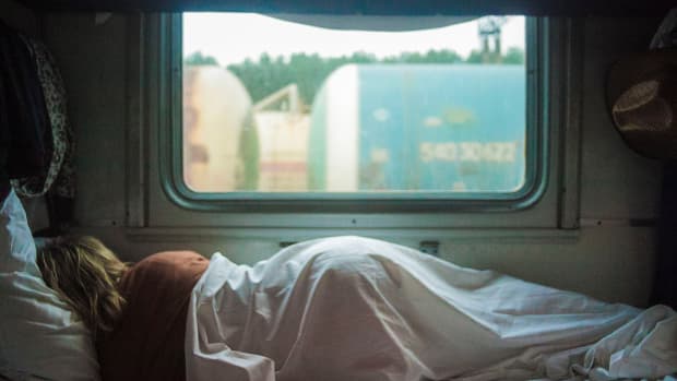 woman sleeping in trailer RV bed