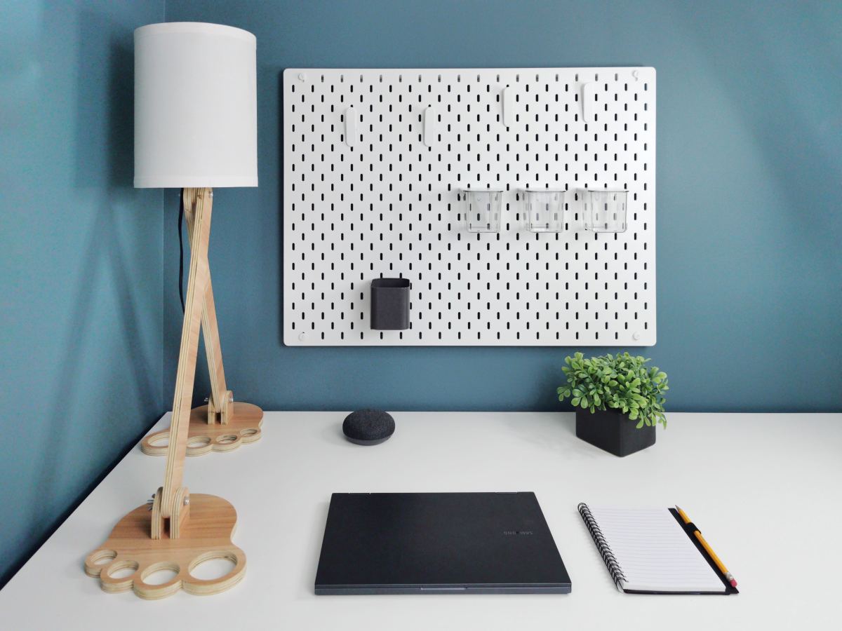 Woman Uses Extra Wallpaper to Cover Pegboards for Seamless Storage
